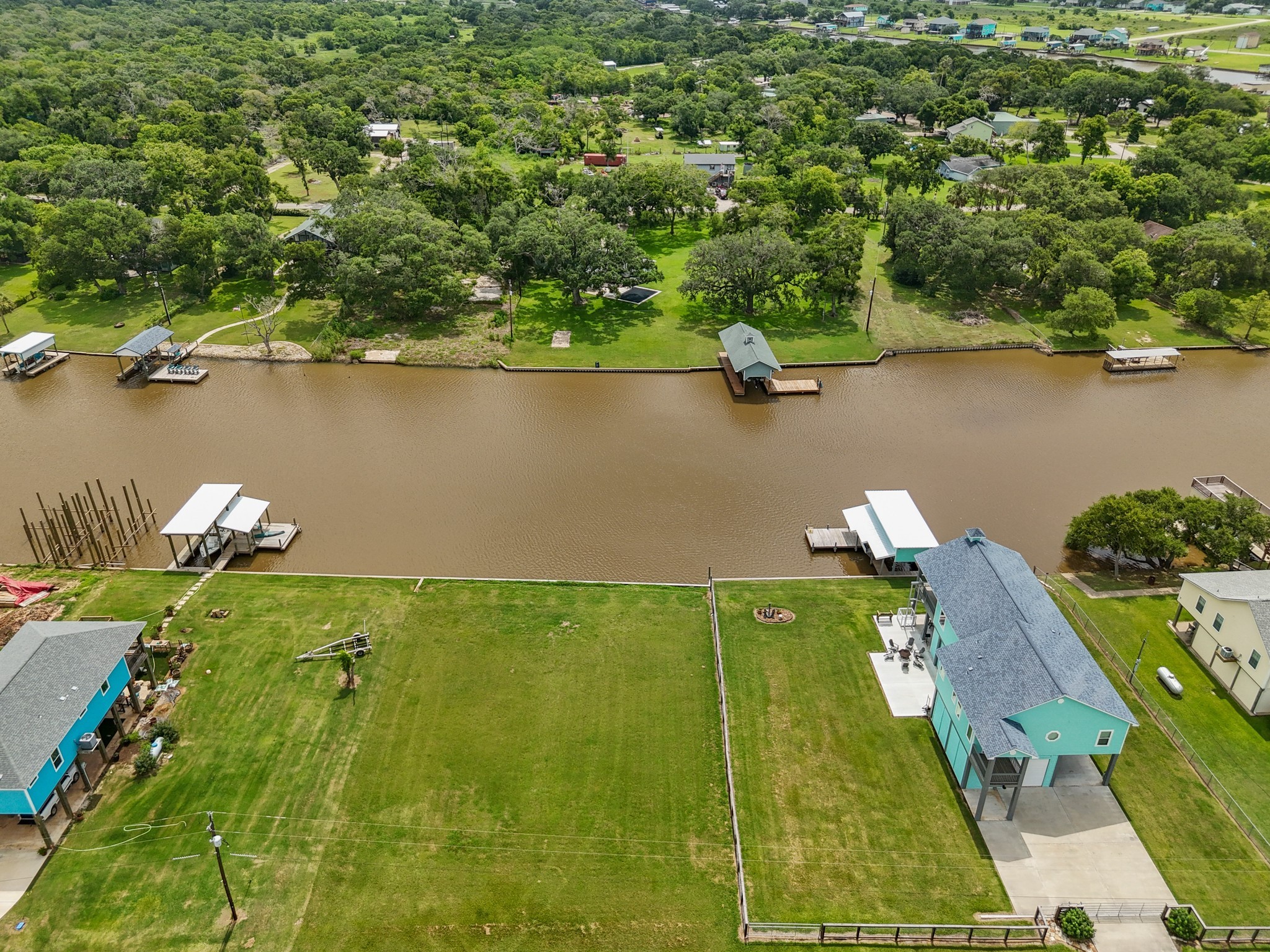 6 County Road 291 Sargent, TX 77414 - Photo 3 of 19 an aerial view of a house with a yard and lake view