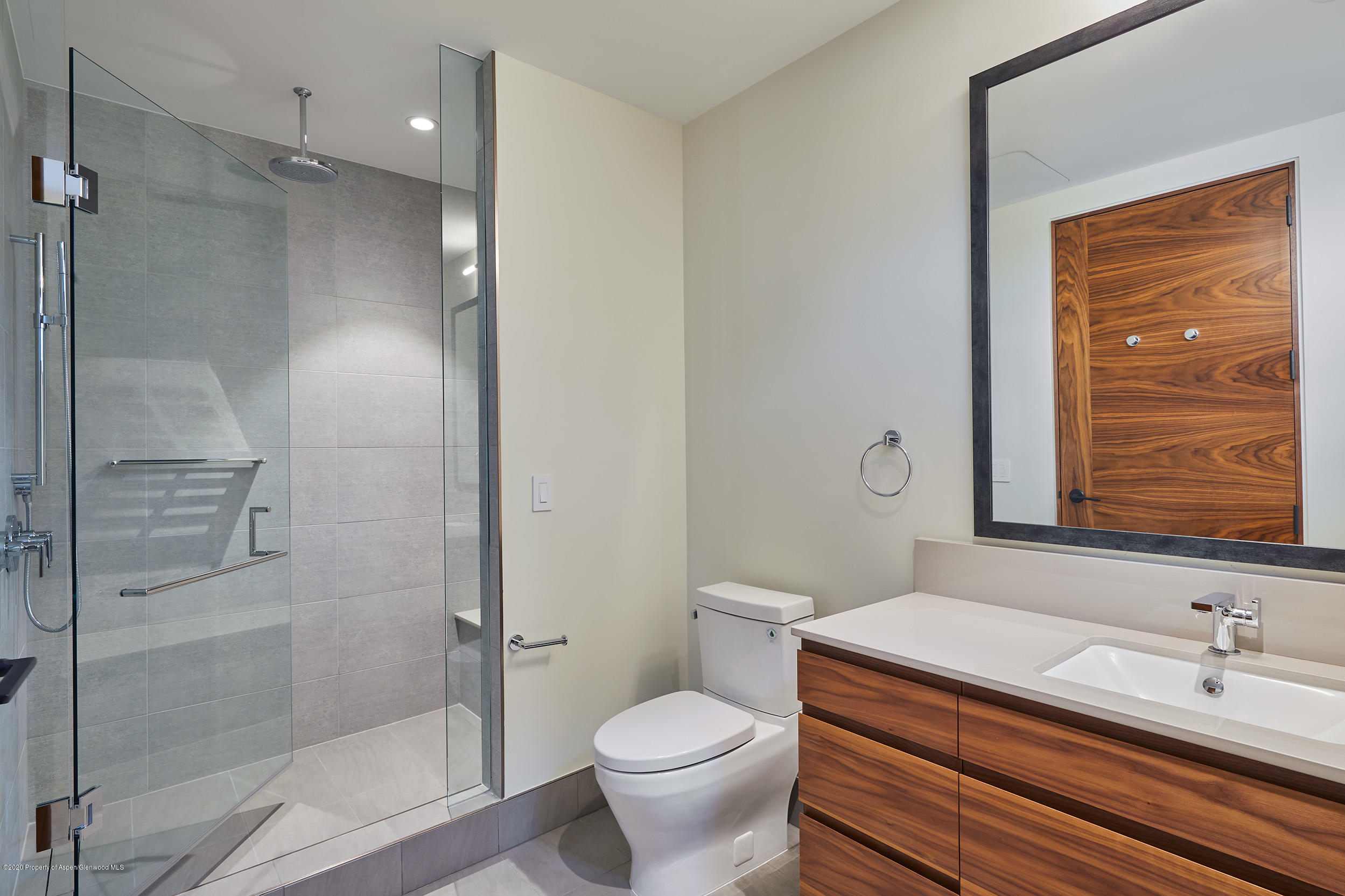 45 Wood Road, Unit 603 WEST Snowmass Village, CO 81615 - Photo 12 of 14 a bathroom with a granite countertop toilet a sink and a mirror