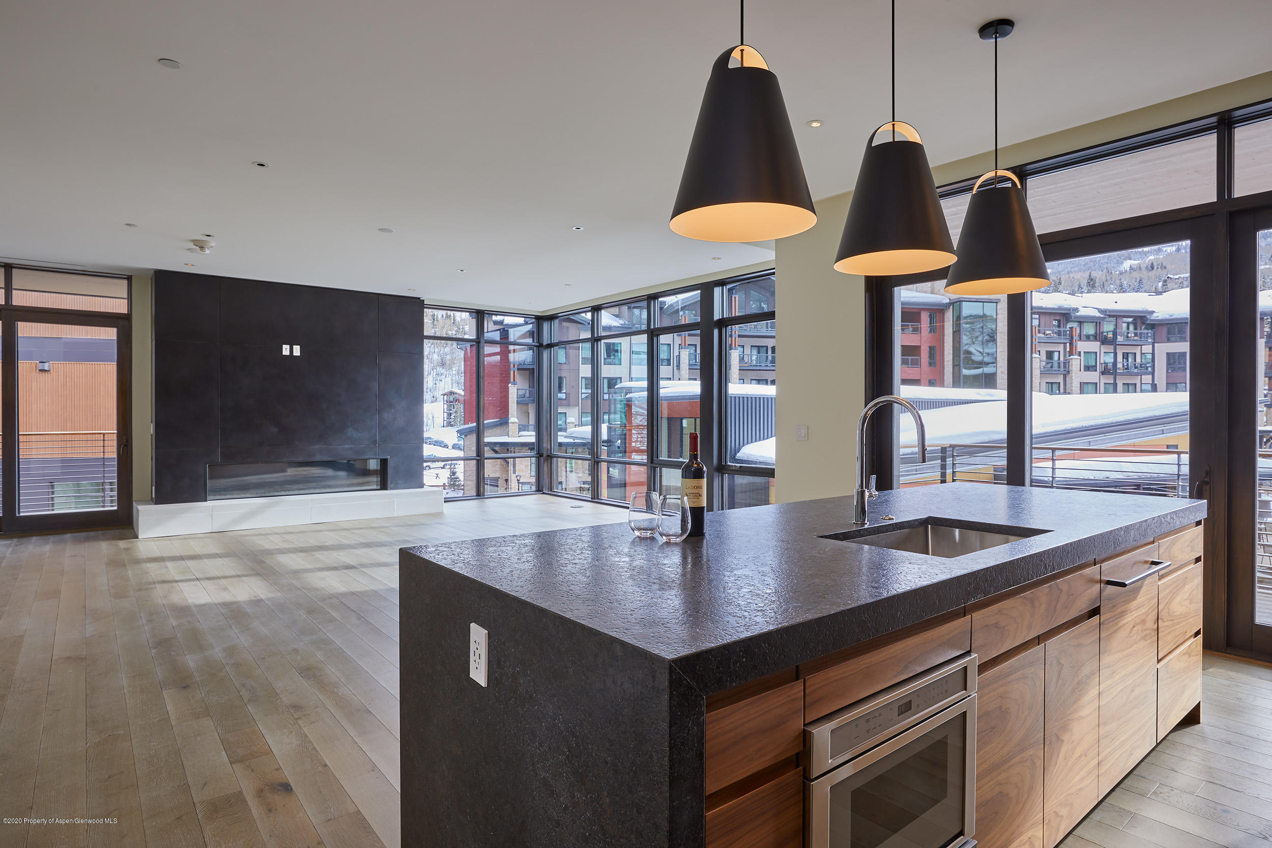 45 Wood Road, Unit 603 WEST Snowmass Village, CO 81615 - Photo 2 of 14 a kitchen with stainless steel appliances granite countertop a sink and a wooden floor