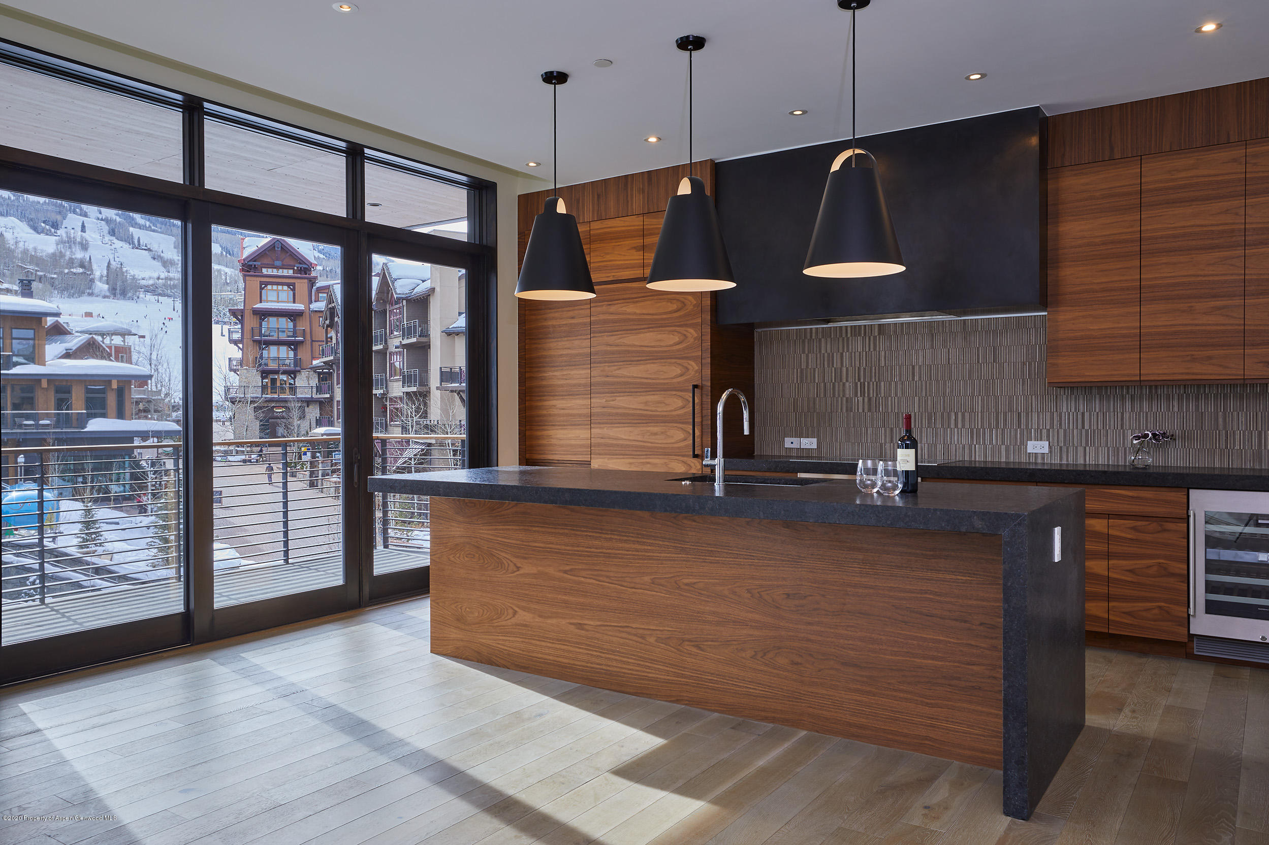 45 Wood Road, Unit 603 WEST Snowmass Village, CO 81615 - Photo 5 of 14 a view of kitchen with granite countertop cabinets and outdoor space
