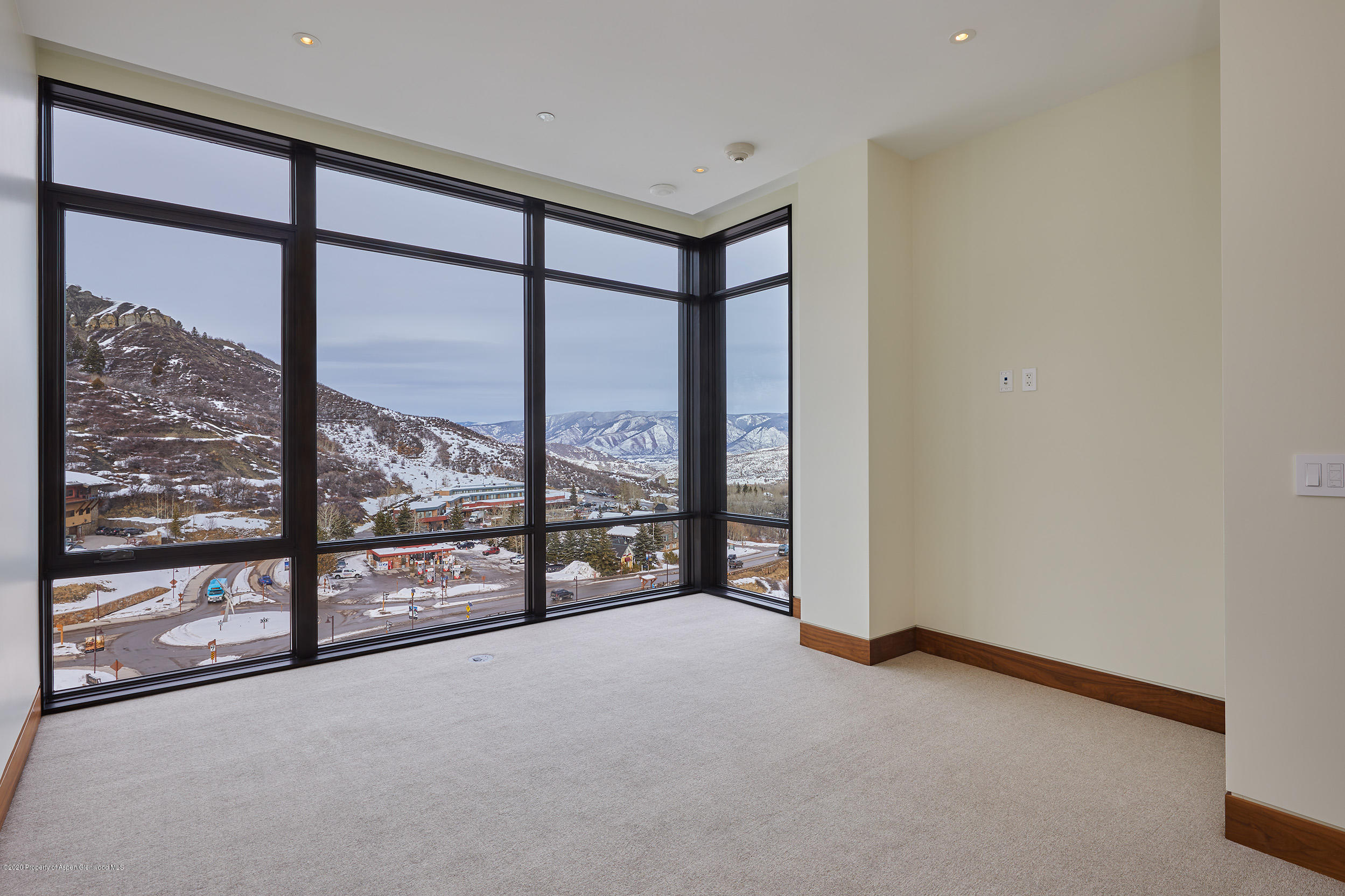 45 Wood Road, Unit 603 WEST Snowmass Village, CO 81615 - Photo 8 of 14 an empty room with sliding glass door and mountain view