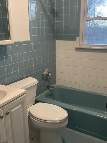 a bathroom with a sink a toilet and a bathtub