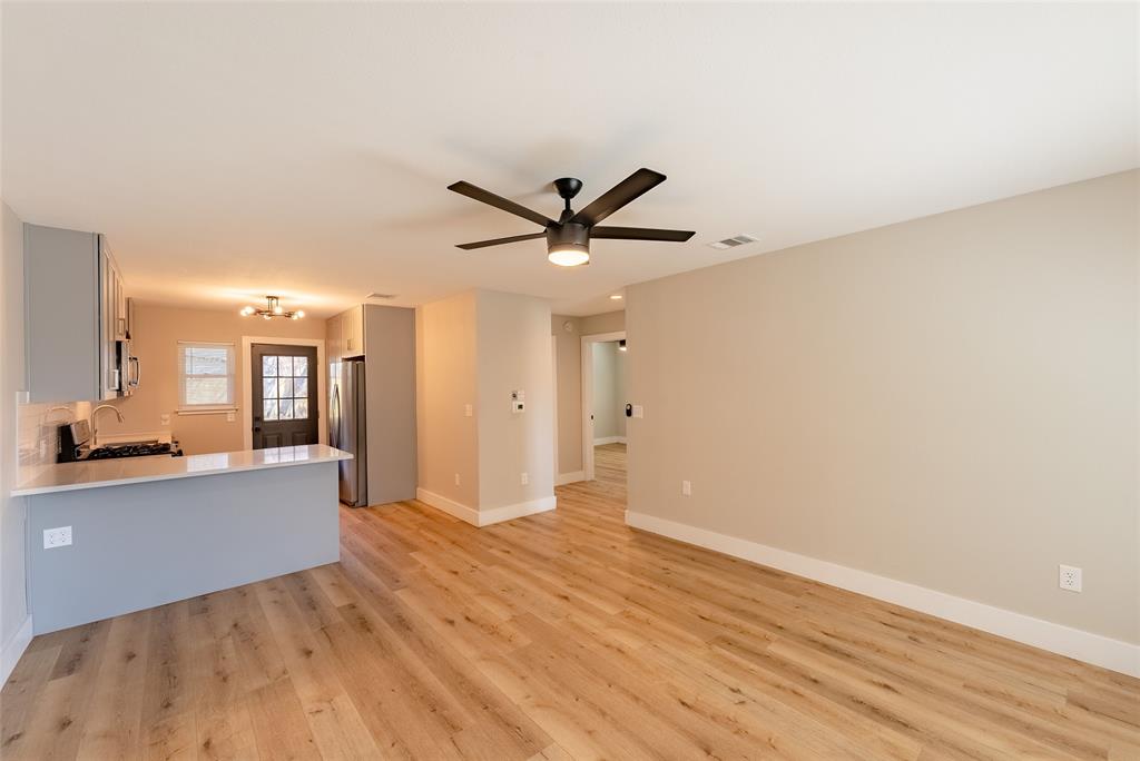 4306 Shallowbrook Trail Austin, TX 78744 - Photo 4 of 16 a view of a livingroom with a hardwood floor and a ceiling fan