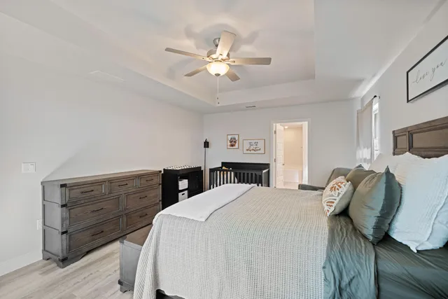 a bed room with a bed and a ceiling fan