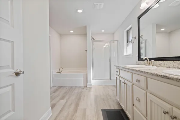 a bathroom with a sink a mirror and a shower