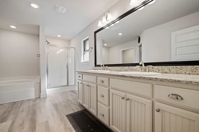 a bathroom with a sink a mirror and a bathtub