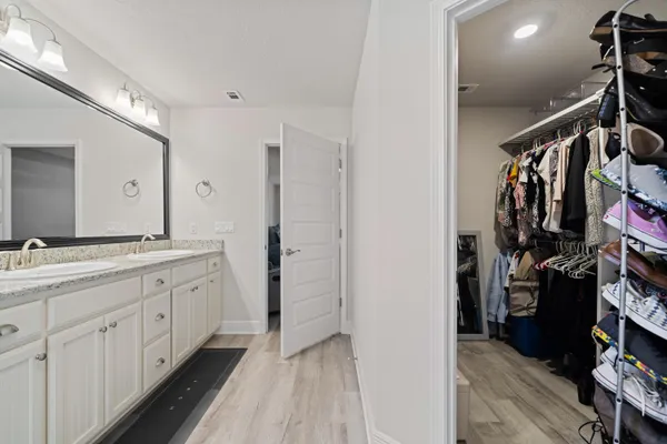 a bathroom with a double vanity sink and a mirror