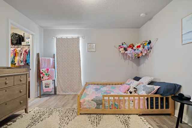 a bedroom with furniture and wooden floor