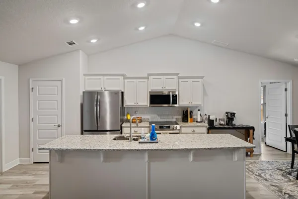 a kitchen with counter top space cabinets and stainless steel appliances