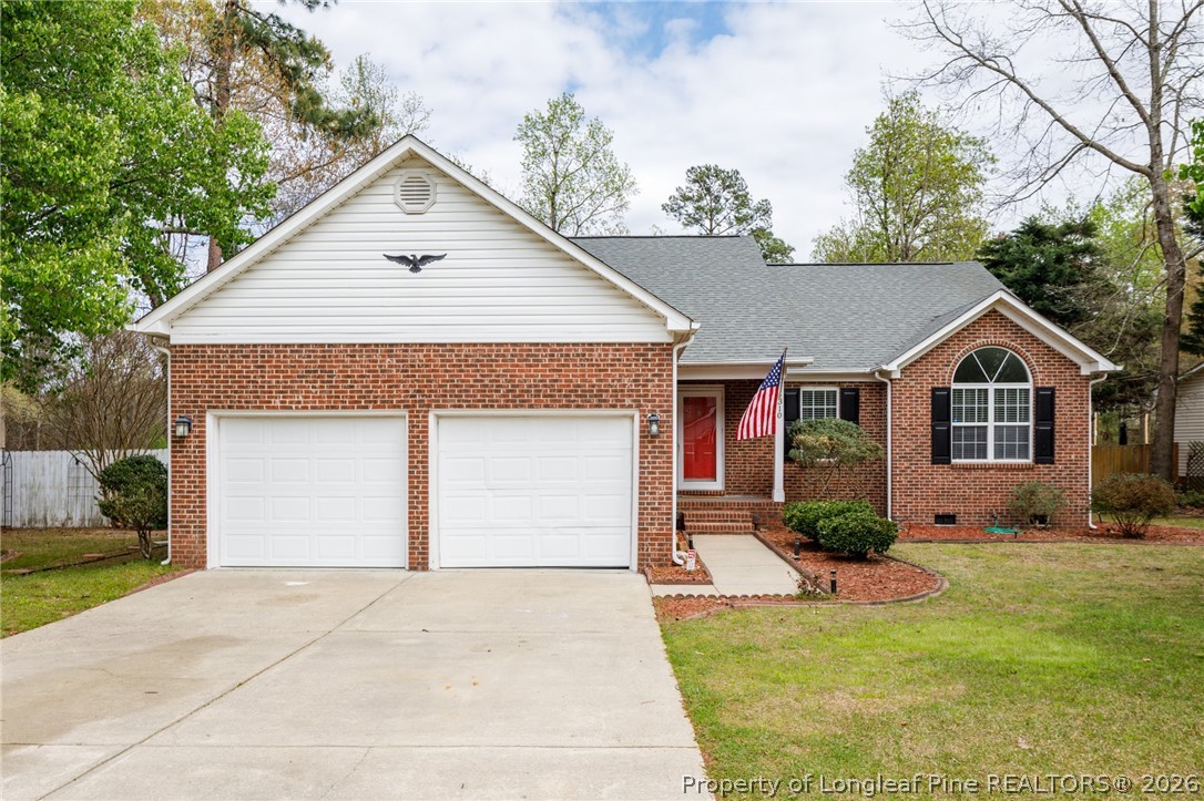 310 Timberidge Drive Raeford, NC 28376 - Photo 1 of 30 a front view of a house with a yard and garage