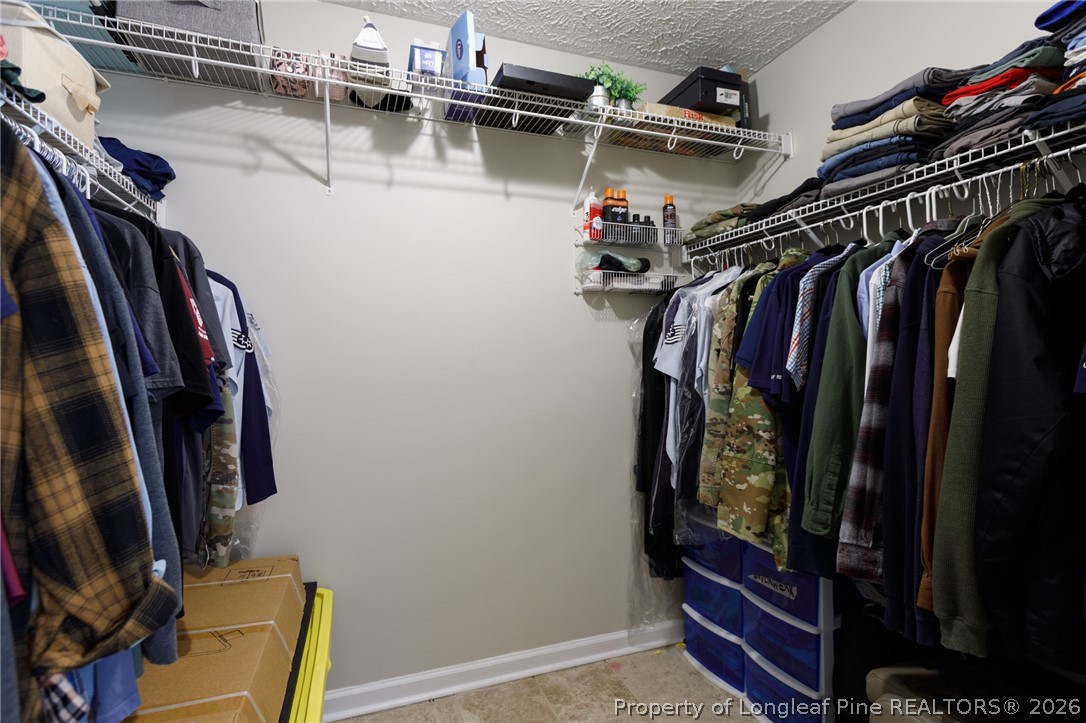 310 Timberidge Drive Raeford, NC 28376 - Photo 22 of 30 a view of walk in closet with clothes and shoes