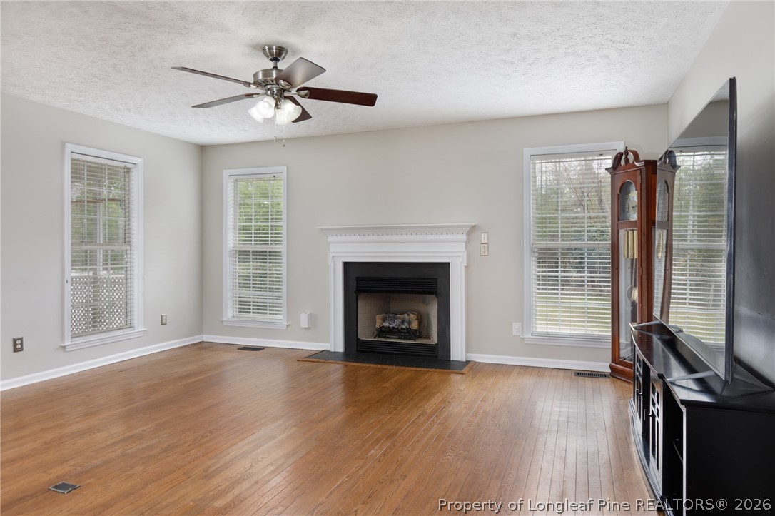 310 Timberidge Drive Raeford, NC 28376 - Photo 7 of 30 a view of an empty room with wooden floor fireplace and a window