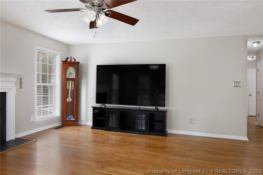 310 Timberidge Drive Raeford, NC 28376 - Photo 8 of 30 wooden floor in an empty room with a fireplace