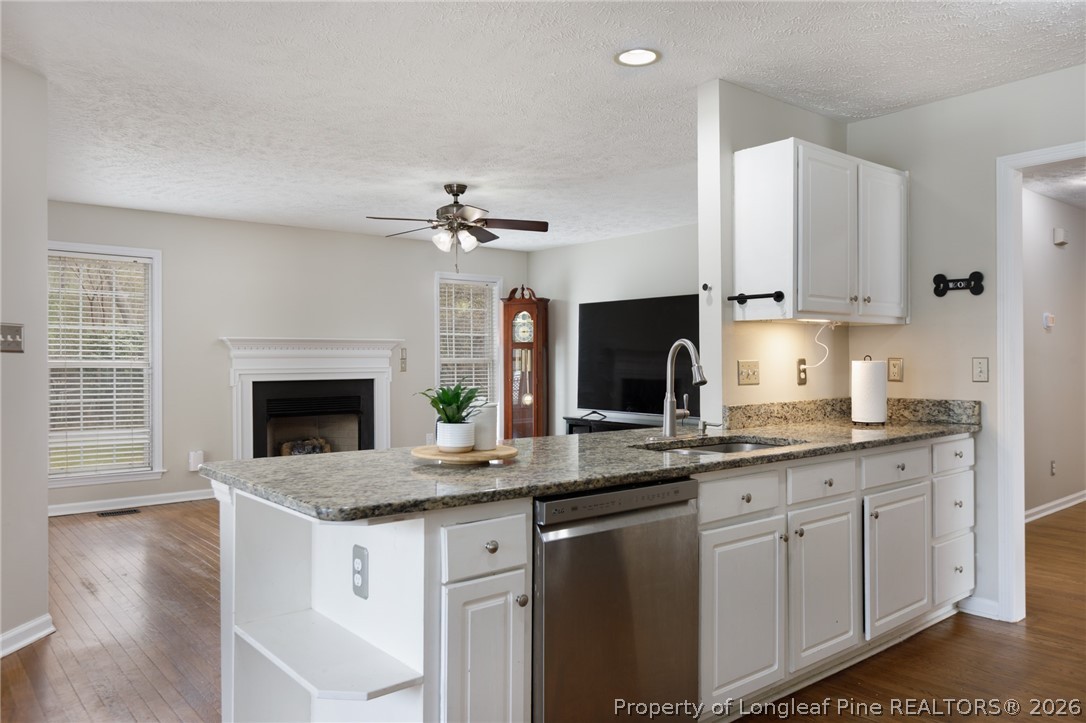 310 Timberidge Drive Raeford, NC 28376 - Photo 10 of 30 a kitchen with granite countertop a sink stainless steel appliances and cabinets