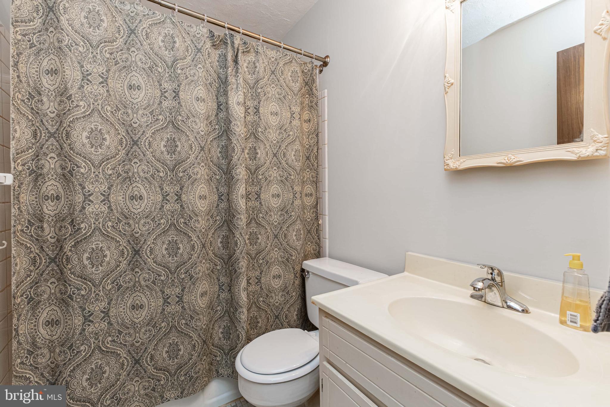 6550 Tip Hill Drive La Plata, MD 20646 - Photo 9 of 24 a bathroom with a toilet sink and mirror