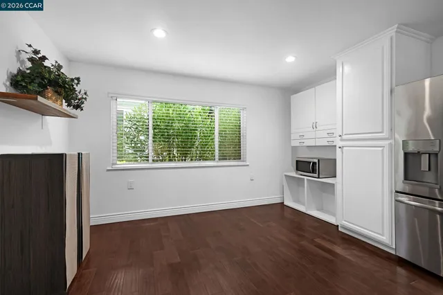 a front view of a house with a yard and potted plants