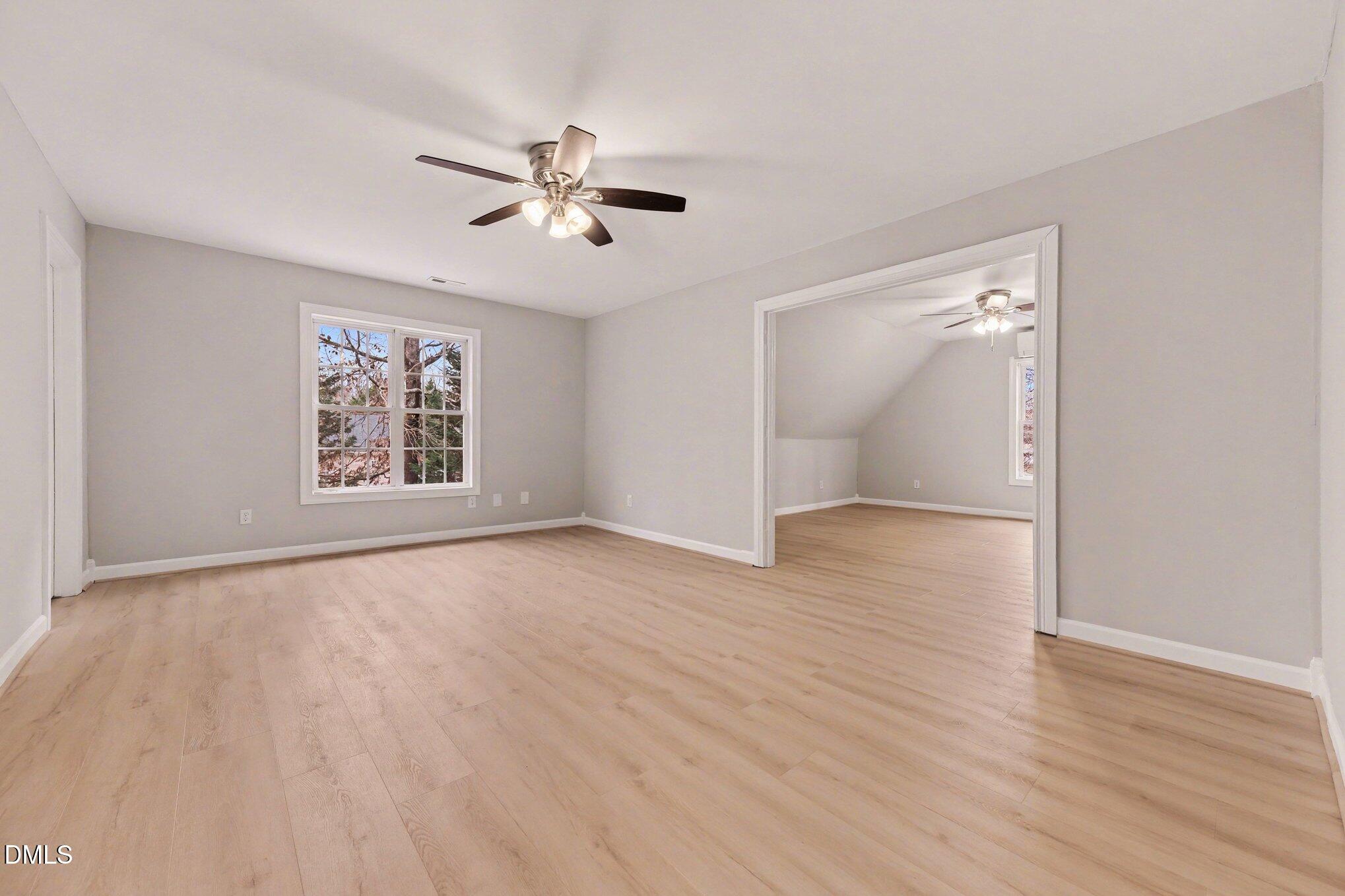 4613 Cherrybark Lane Raleigh, NC 27616 - Photo 16 of 27 a view of an empty room with wooden floor and a window