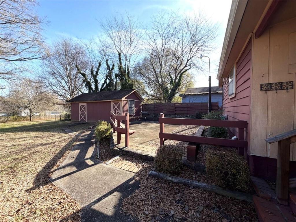421 Cedar Avenue Southwest Rome, GA 30161 - Photo 18 of 26 a backyard of a house with barbeque oven table and chairs