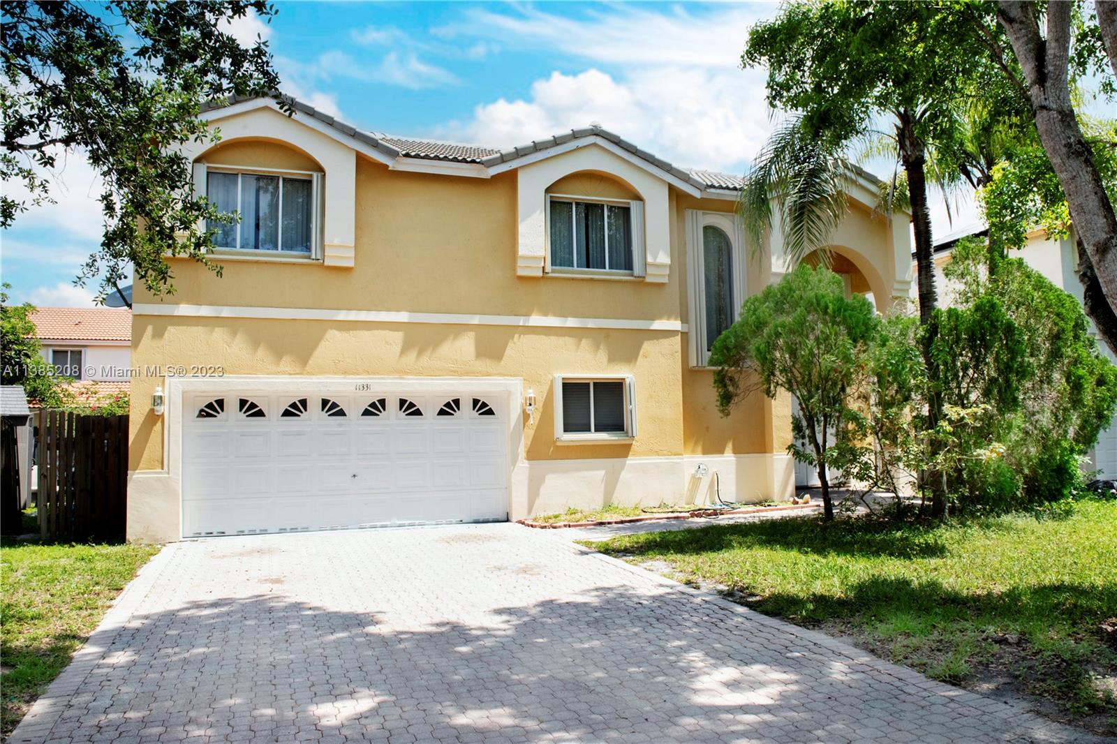 11331 Rockinghorse Road Cooper City, FL 33026 - Photo 2 of 10 a front view of a house with a yard and garage