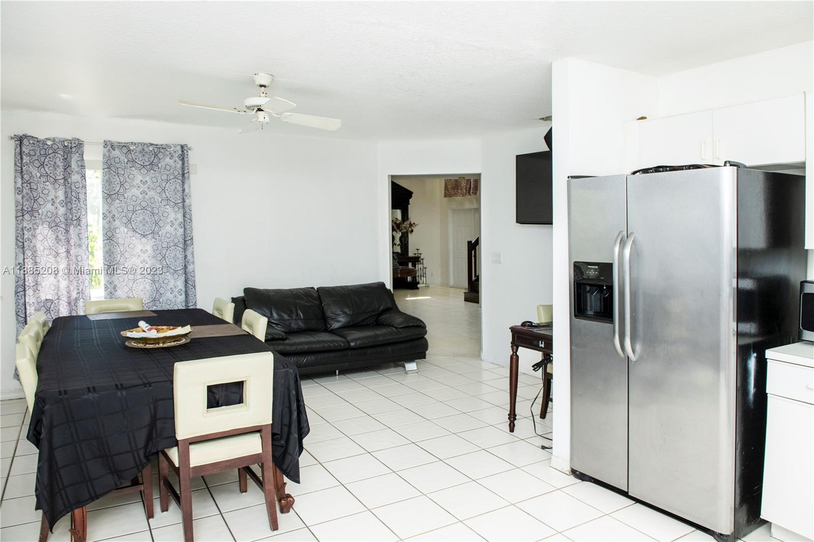 11331 Rockinghorse Road Cooper City, FL 33026 - Photo 6 of 10 a kitchen with a refrigerator and a stove top oven