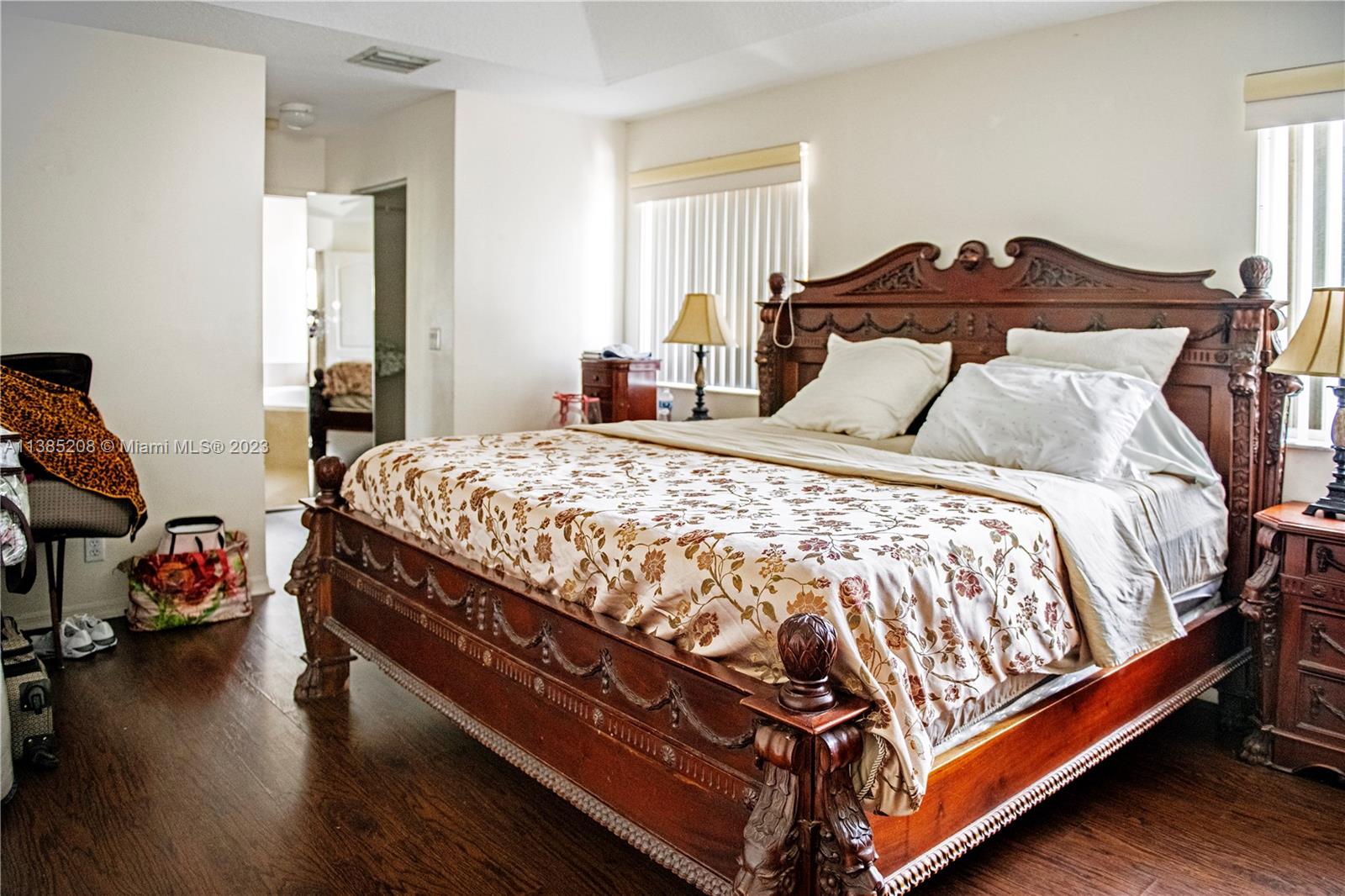 11331 Rockinghorse Road Cooper City, FL 33026 - Photo 8 of 10 a bedroom with a bed and wooden floor