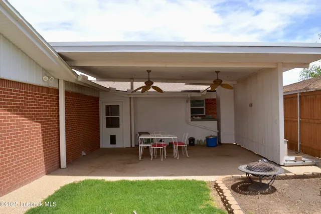 a view of a patio with table and chairs