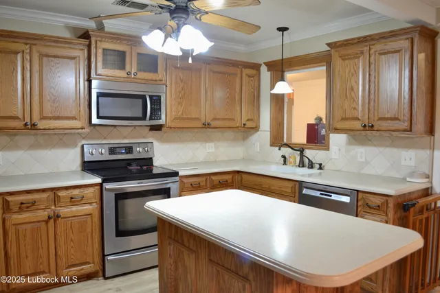 a kitchen with stainless steel appliances granite countertop a sink a microwave cabinets and a counter top space