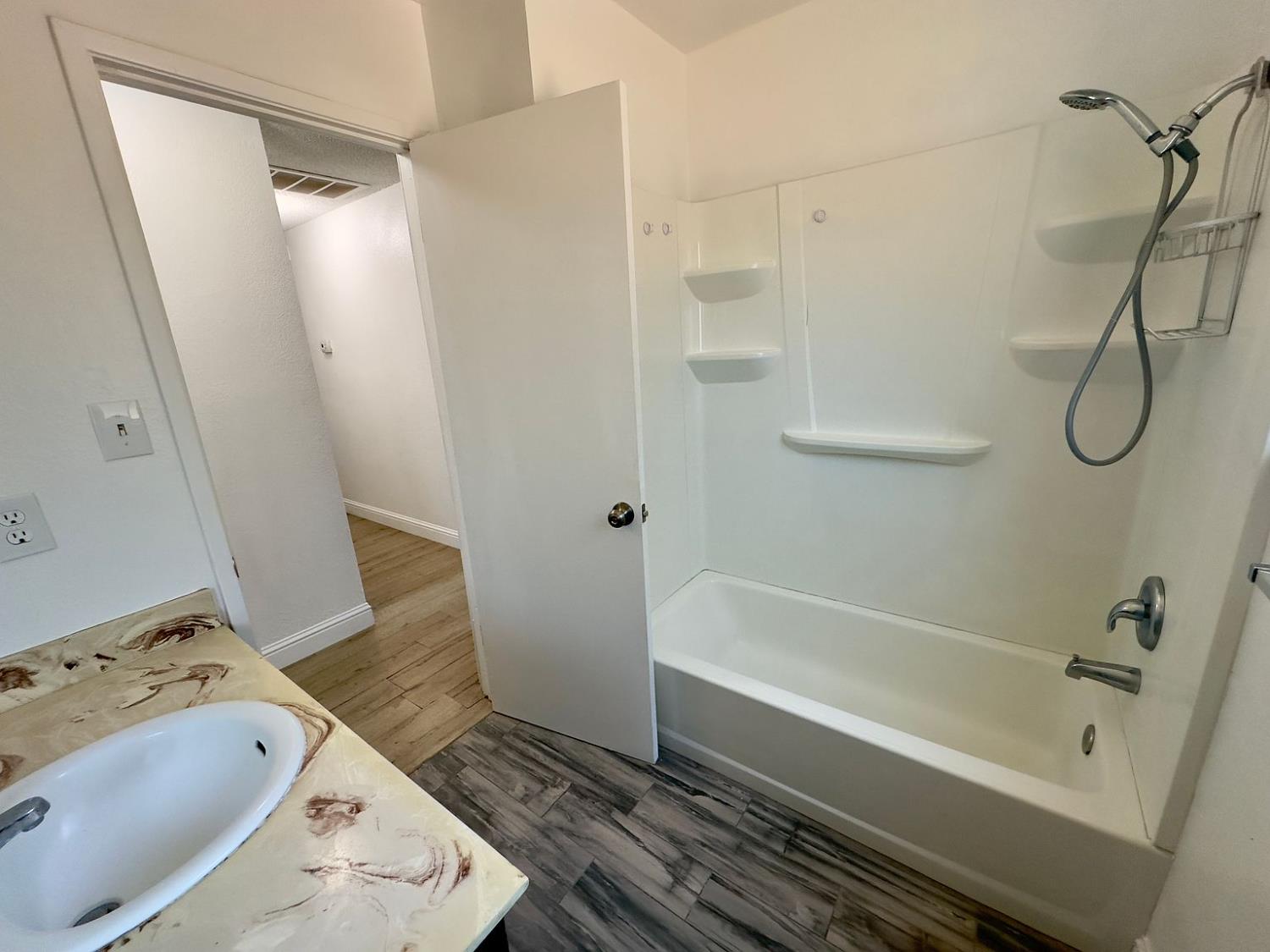 5743 Haskell Avenue Carmichael, CA 95608 - Photo 15 of 47 a bathroom with a tub shower and a sink