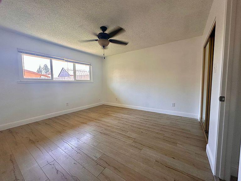 5743 Haskell Avenue Carmichael, CA 95608 - Photo 17 of 47 an empty room with wooden floor fan and windows