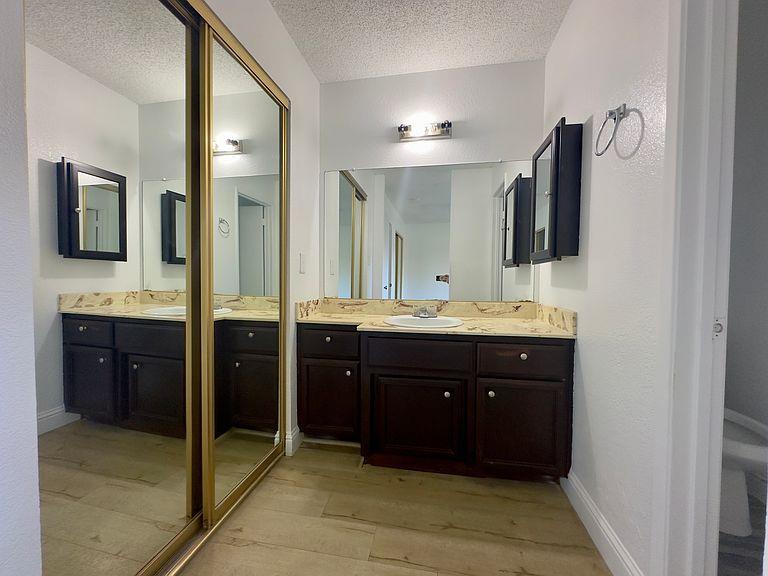 5743 Haskell Avenue Carmichael, CA 95608 - Photo 19 of 47 a bathroom with a double vanity sink and mirror