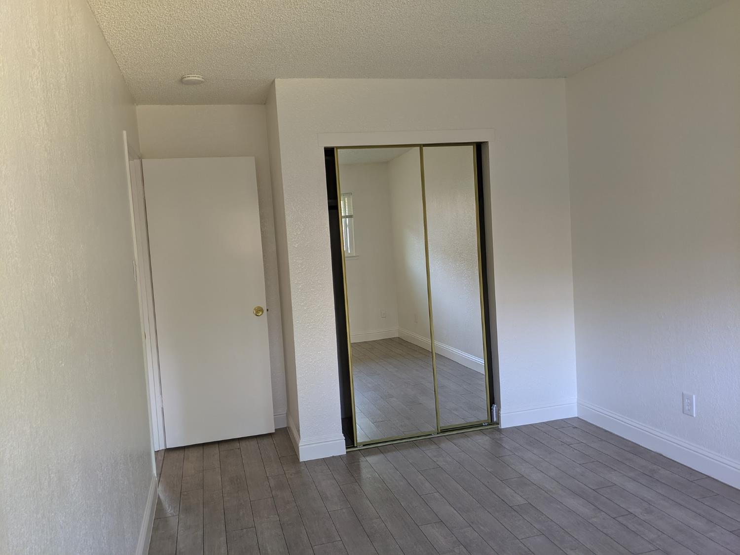 5743 Haskell Avenue Carmichael, CA 95608 - Photo 34 of 47 a view of an empty room with wooden floor and closet