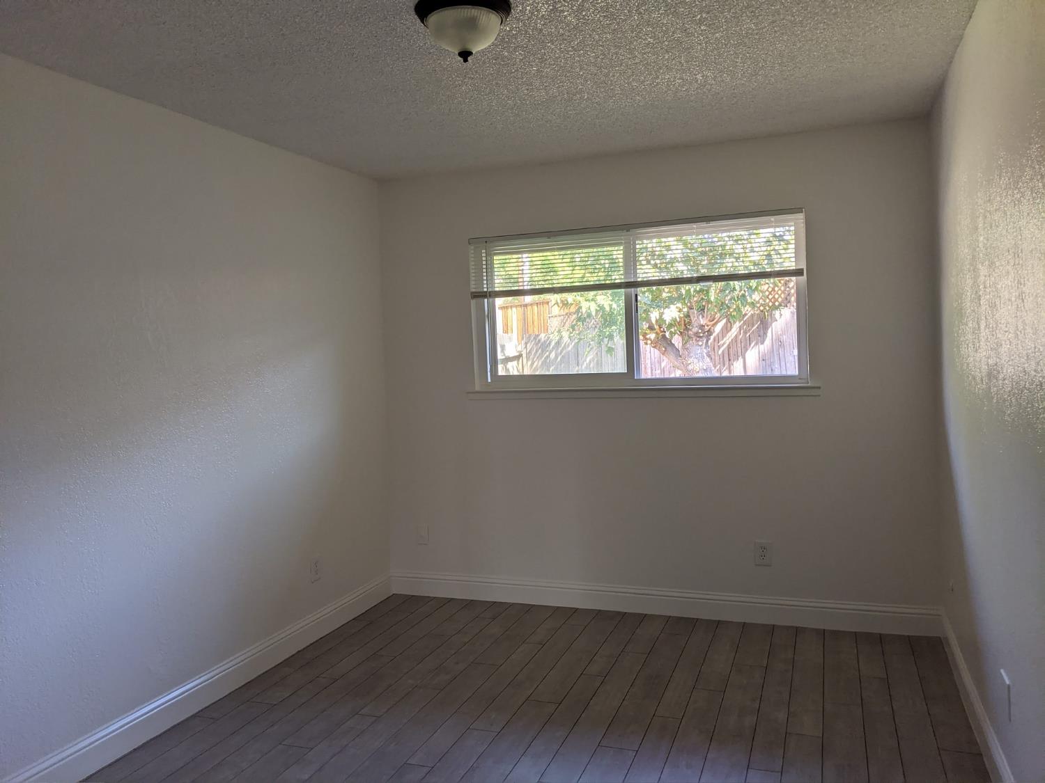 5743 Haskell Avenue Carmichael, CA 95608 - Photo 35 of 47 an empty room with wooden floor and windows