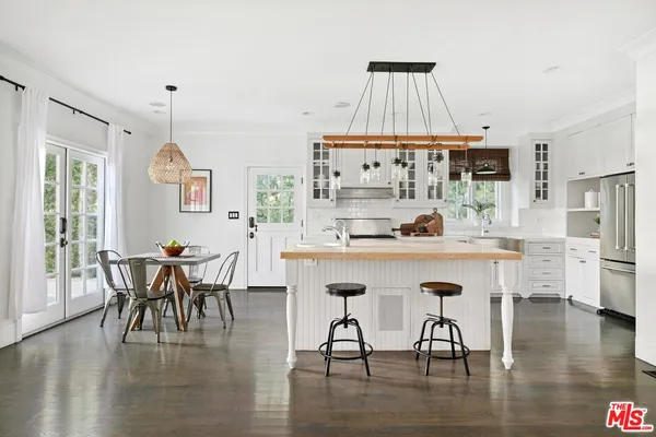 a dining table with chairs and wooden floor