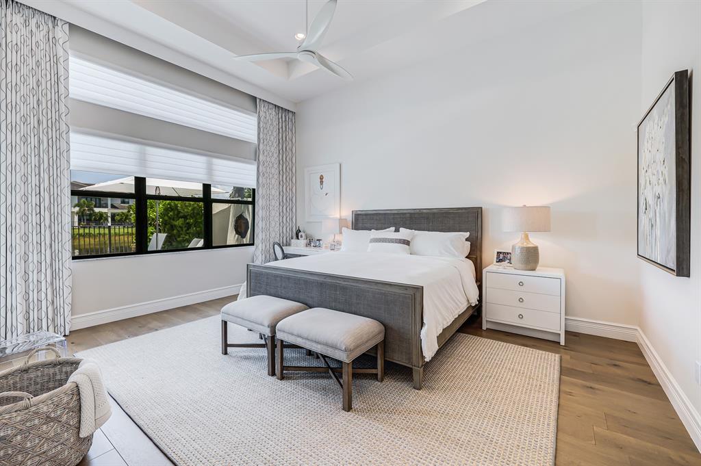 17401 Santaluce Manor Boca Raton, FL 33496 - Photo 25 of 84 a bedroom with a bed and a large window