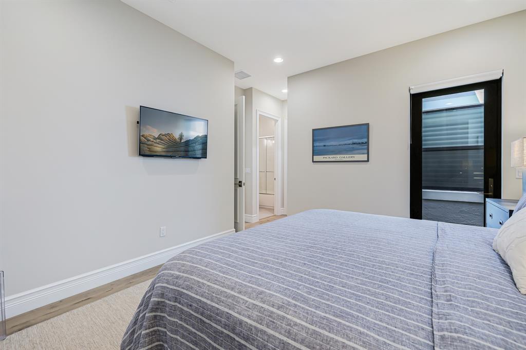 17401 Santaluce Manor Boca Raton, FL 33496 - Photo 37 of 84 a bedroom with a bed and a flat screen tv