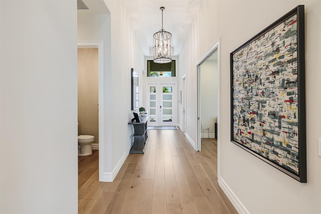 17401 Santaluce Manor Boca Raton, FL 33496 - Photo 5 of 84 a hallway with wooden floor chandelier and entryway