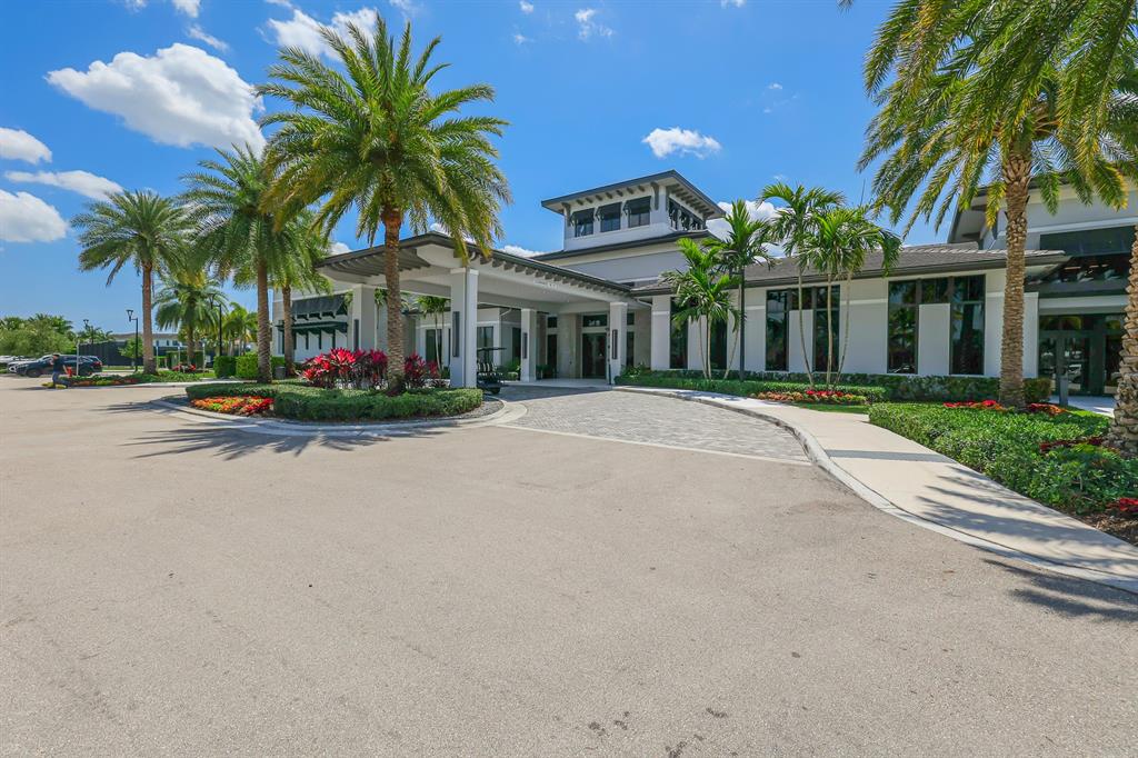 17401 Santaluce Manor Boca Raton, FL 33496 - Photo 74 of 84 front view of house with a yard and palm trees