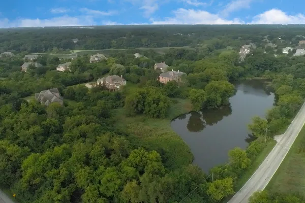 a view of a lake and green valley