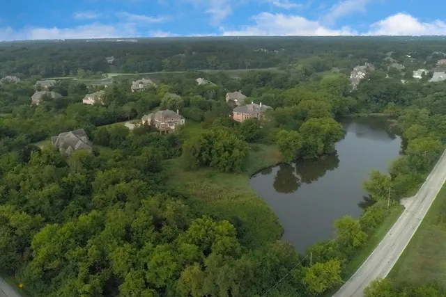a view of a lake and green valley