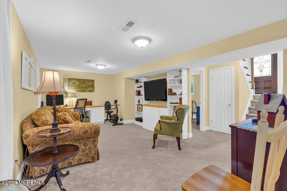 54 Salem Hill Road Howell, NJ 07731 - Photo 43 of 71 a living room with furniture and a flat screen tv