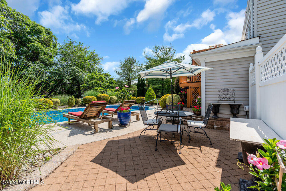 54 Salem Hill Road Howell, NJ 07731 - Photo 49 of 71 a view of a patio with table and chairs potted plants with wooden fence