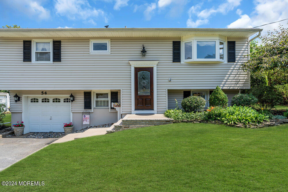 54 Salem Hill Road Howell, NJ 07731 - Photo 6 of 71 a front view of a house with a garden and yard