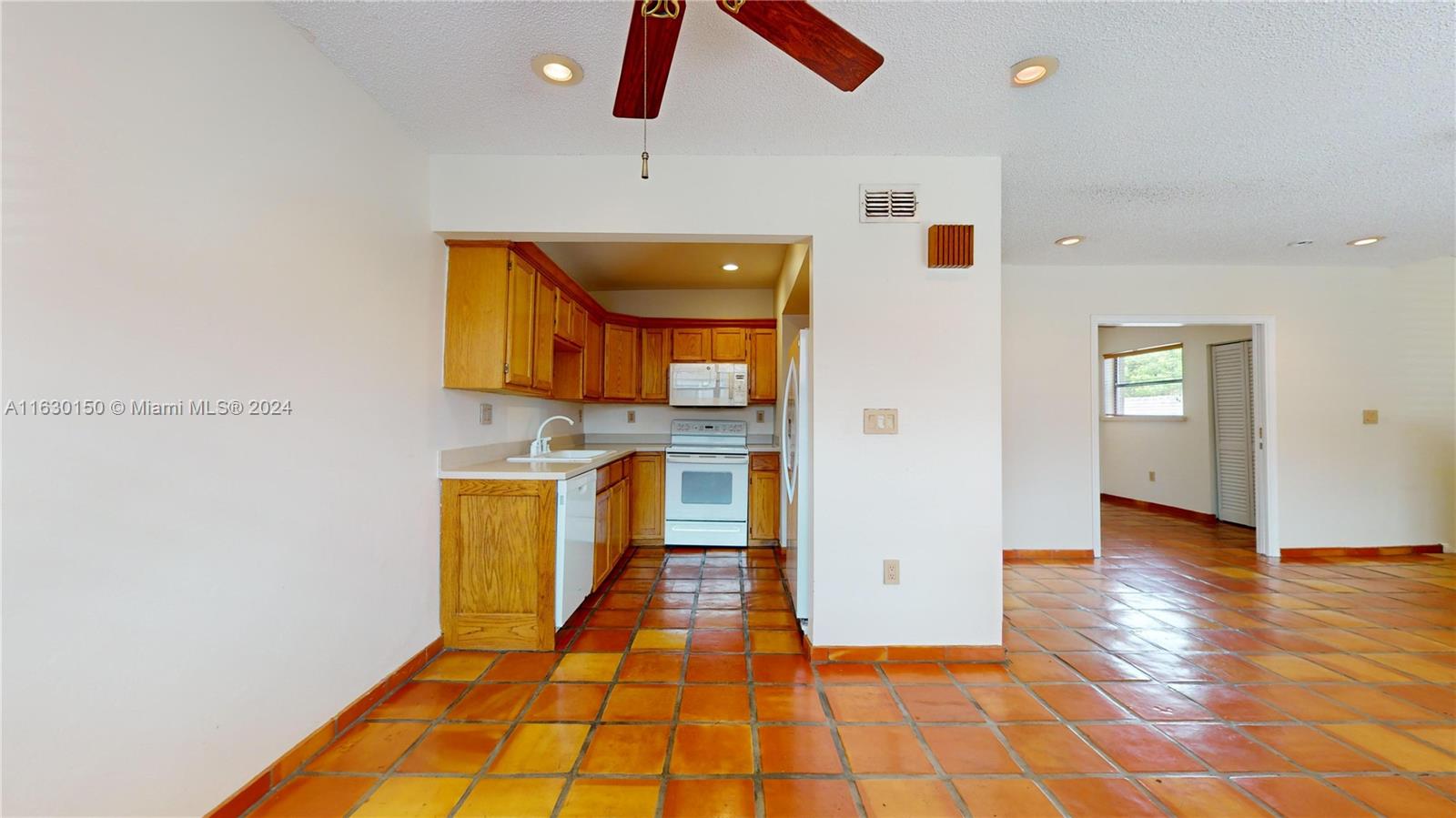 10665 Southwest 113th Place, Unit 95D Miami, FL 33176 - Photo 11 of 42 a hallway with washer and dryer