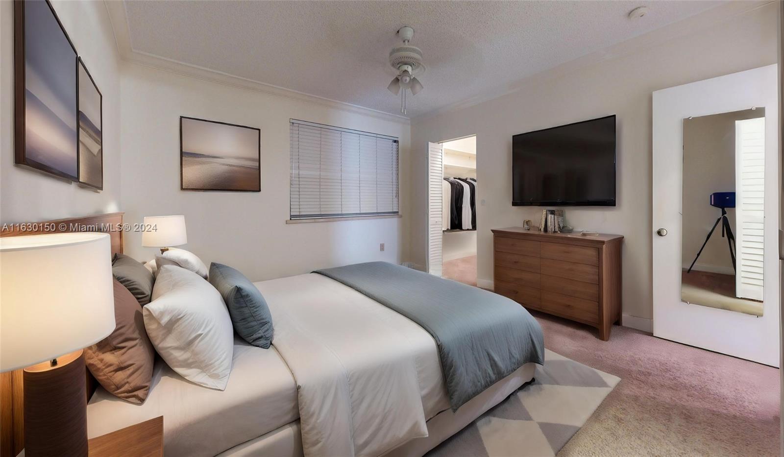 10665 Southwest 113th Place, Unit 95D Miami, FL 33176 - Photo 16 of 42 a bedroom with a bed and a flat screen tv