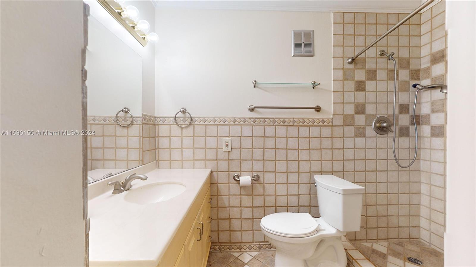 10665 Southwest 113th Place, Unit 95D Miami, FL 33176 - Photo 19 of 42 a bathroom with a sink toilet and shower