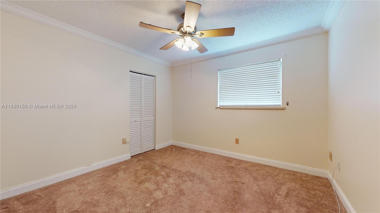 10665 Southwest 113th Place, Unit 95D Miami, FL 33176 - Photo 21 of 42 an empty room with a window and a fan