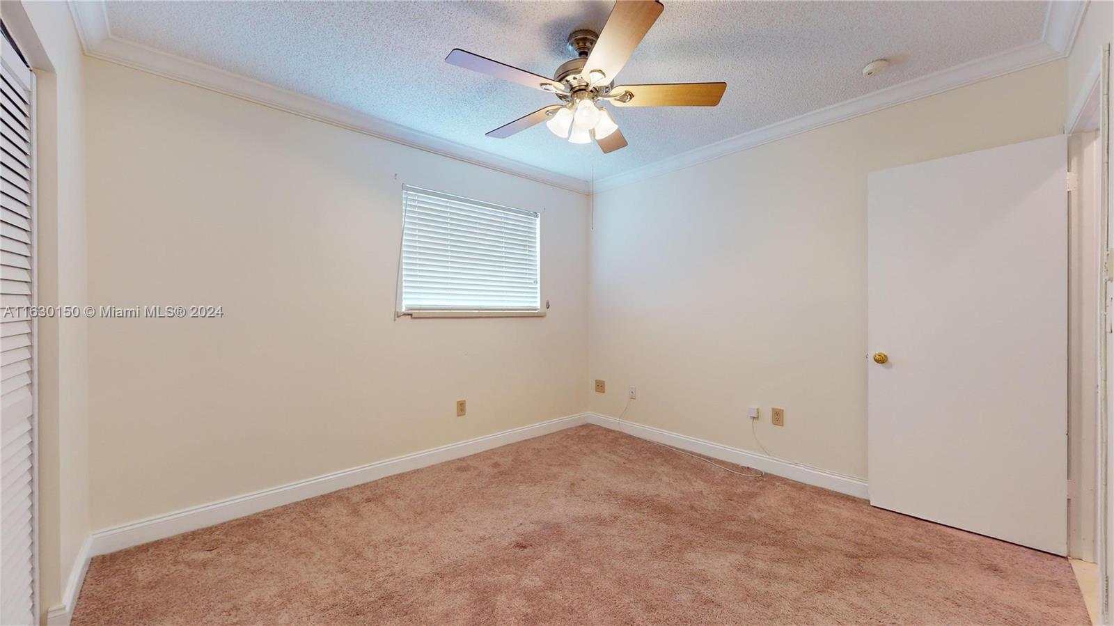 10665 Southwest 113th Place, Unit 95D Miami, FL 33176 - Photo 23 of 42 an empty room with a window and a fan