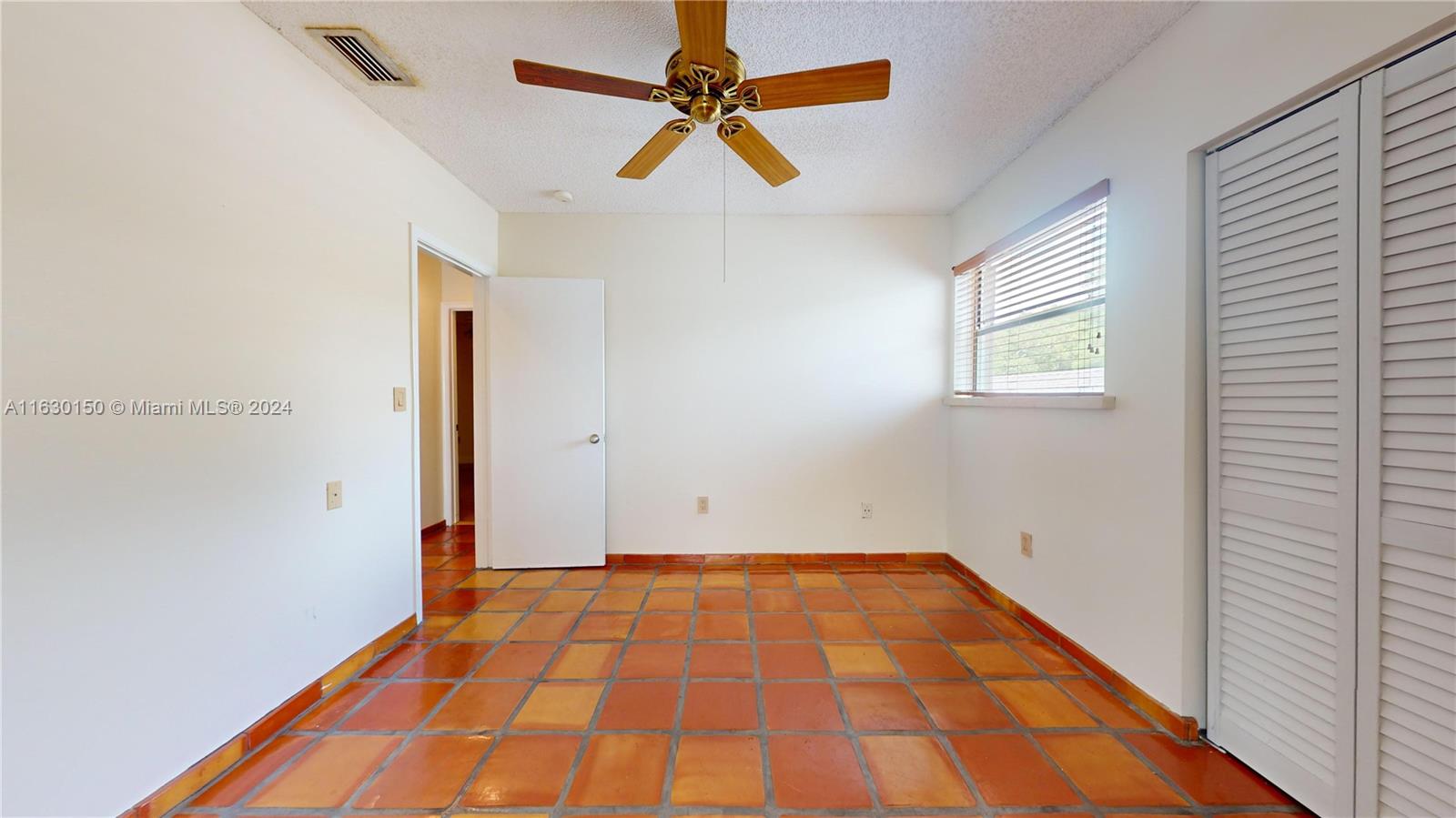 10665 Southwest 113th Place, Unit 95D Miami, FL 33176 - Photo 24 of 42 a view of room with a ceiling fan and window