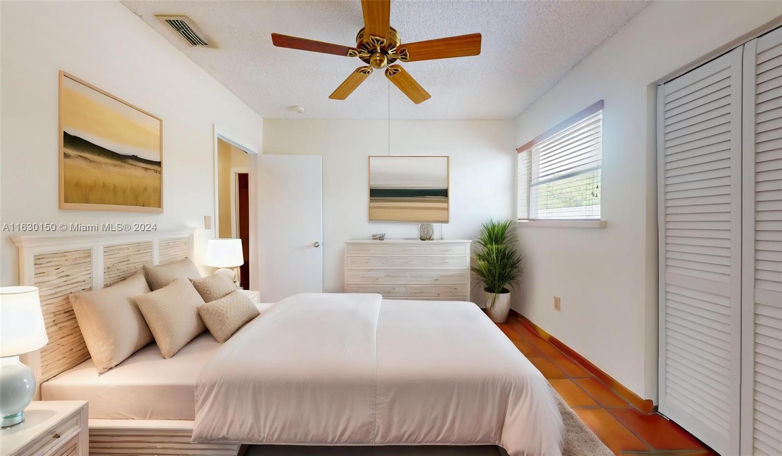 10665 Southwest 113th Place, Unit 95D Miami, FL 33176 - Photo 25 of 42 a bedroom with a bed mirror and window