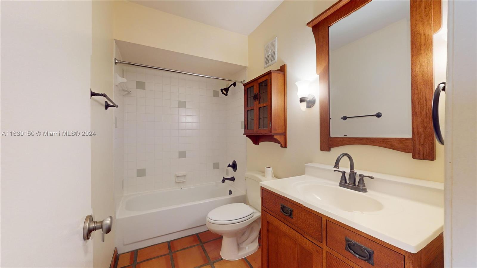 10665 Southwest 113th Place, Unit 95D Miami, FL 33176 - Photo 27 of 42 a bathroom with a sink toilet vanity and shower